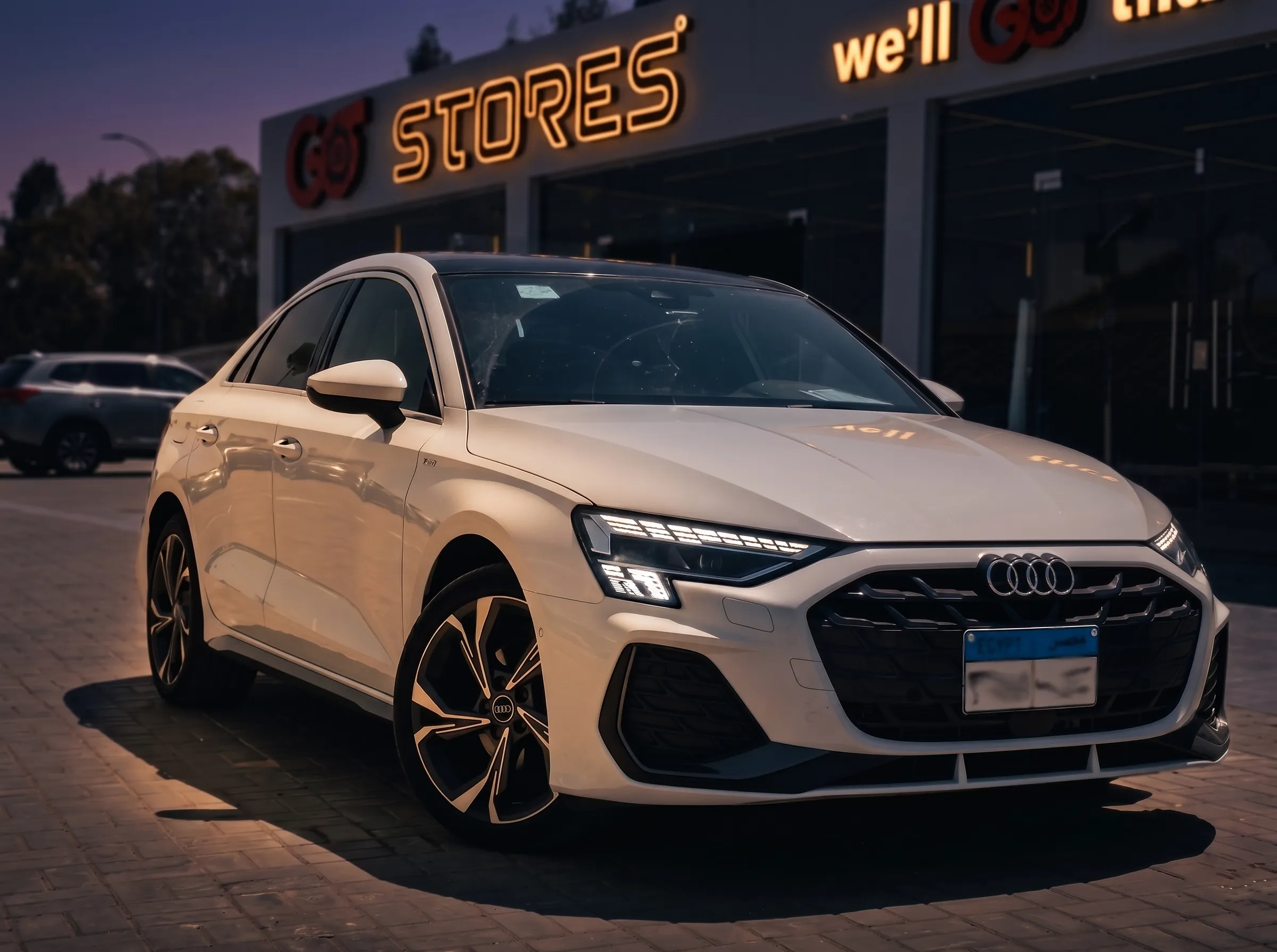 White Audi sedan, dusk grading — GO Standard tier
